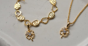 Four leaf clover charm on gold rope chain necklace and Verona Signature Bracelet