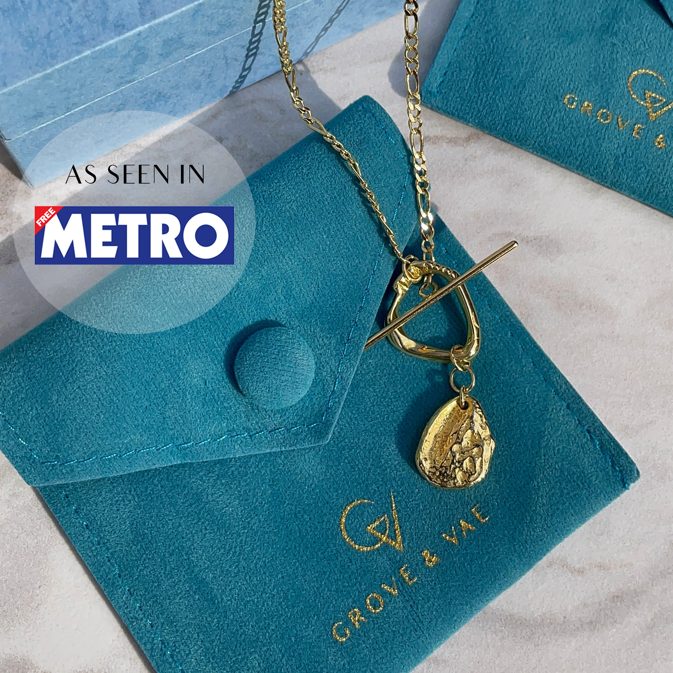 Verona Gold Figaro T-Bar Necklace on Grove & Vae Pouch with as seen in Metro newspaper sticker